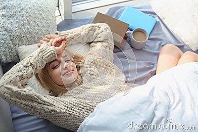 Beautiful young woman awaking and smiling at home, top view. Stock Photo