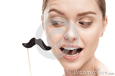 Beautiful young woman with black mustaches on stick Stock Photo