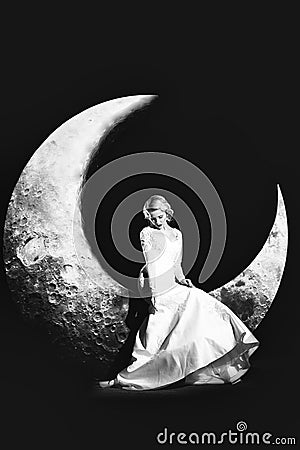 Woman in dress on moon Stock Photo