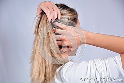 Adventurous Hair Exploration: Blonde Beauty Unleashing Creative Hairstyles Stock Photo