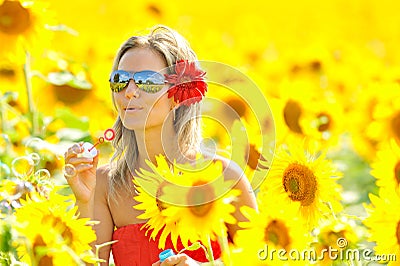 Beautiful young woman blowing soap bubbles outdoor Stock Photo
