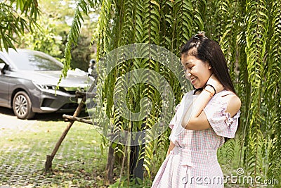 Beautiful young woman in casual clothes walks through green forest in summer and admires wild flowers, concept Leisure of young Stock Photo