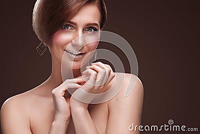 Beautiful Young Woman with Clean Fresh Skin touch own face . Facial treatment . Cosmetology , beauty and spa . Isolated Stock Photo