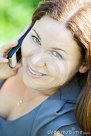 Beautiful young woman close-up portrait speaking on phone Stock Photo