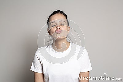 Beautiful young woman closed eyes and pouted lips in anticipation of a kiss. Funny portrait of a woman Stock Photo