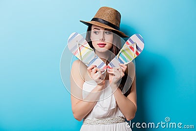 Beautiful young woman with colorful sandals standing in front of Stock Photo