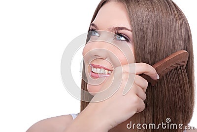 Beautiful young woman combing her hair Stock Photo