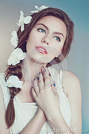 Beautiful young woman with delicate flowers in their hair Stock Photo