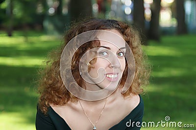 Beautiful young woman in dress with decollete poses Stock Photo