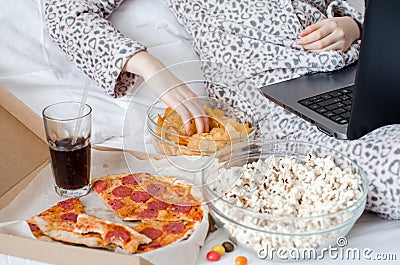 Beautiful young woman eating unhealthy food Stock Photo