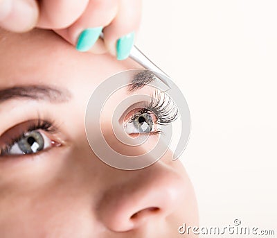 Beautiful young woman eyelash extension. Woman eye with long eyelashes. Beauty salon concept Stock Photo