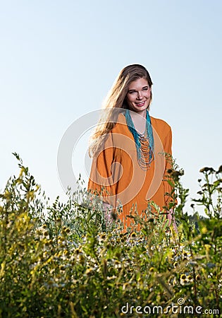 Beautiful young woman in a field. Summer dress Stock Photo