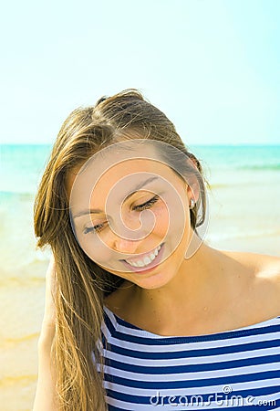 Beautiful Young Woman Girl Sun Tan on the Beach by Ocean Smiling. Candid Shot Authentic Genuine Emotions. Blue Sky Turquoise Sea Stock Photo