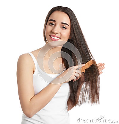 Beautiful young woman with hair comb on white Stock Photo