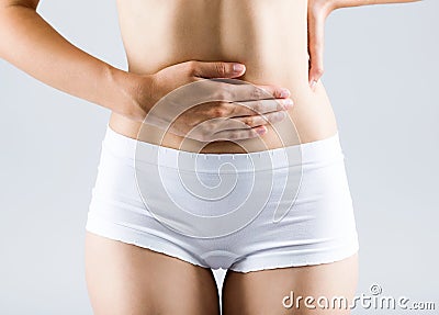 Beautiful young woman with hands on belly-stomach ache. Stock Photo