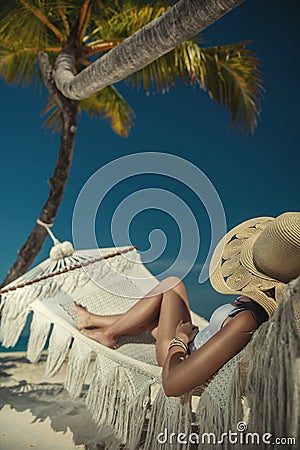 Beautiful young woman with hat on white beach, beautiful scenery with woman in maldives, tropical paradise Stock Photo