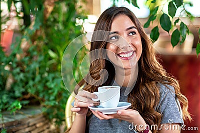 Beautiful young woman having a coffee and smiling Stock Photo