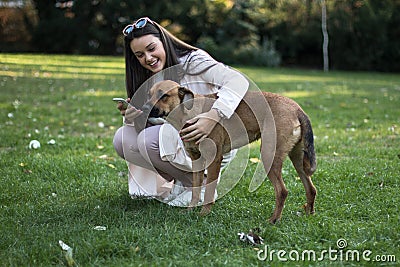 Young woman with her dog in the park Stock Photo