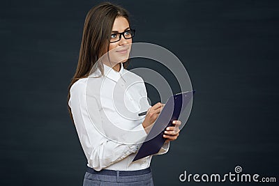 Beautiful young woman holding clipboard with pen thinking. Stock Photo