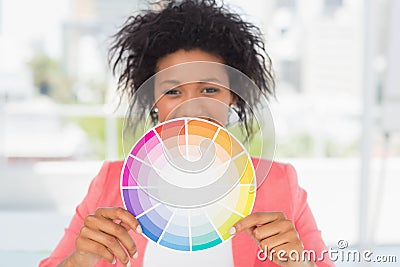 Beautiful young woman holding color wheel Stock Photo