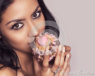 Beautiful young woman holding cup cake with heart Stock Photo