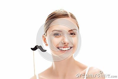 Beautiful young woman holding fake moustache on stick, skin care concept Stock Photo