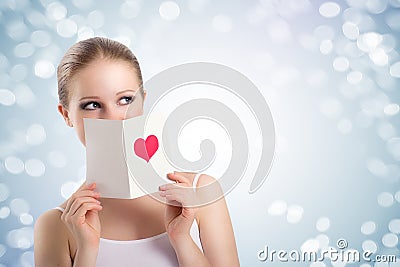 Beautiful young woman holding a valentine postcard Stock Photo