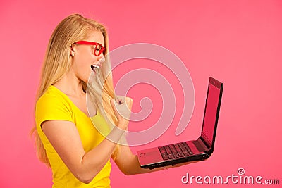 Beautiful young woman holds a laptop gesture surprise and success isoalted Stock Photo