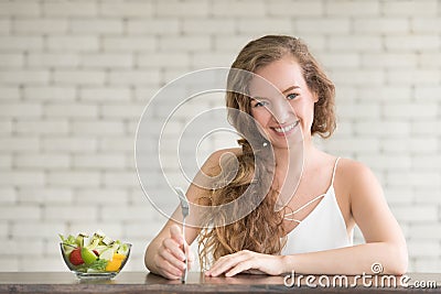 Beautiful young woman in joyful postures with salad bowl Stock Photo