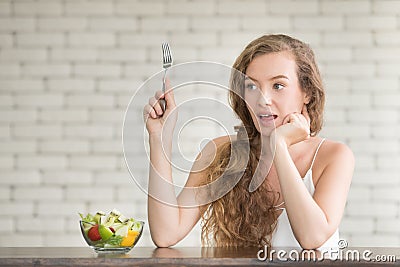 Beautiful young woman in joyful postures with salad bowl Stock Photo