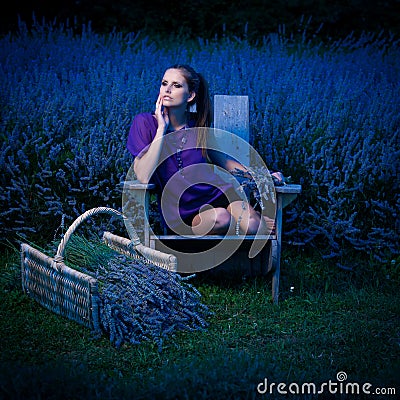 Beautiful young woman on lavander field at dusk - lavanda girl Stock Photo