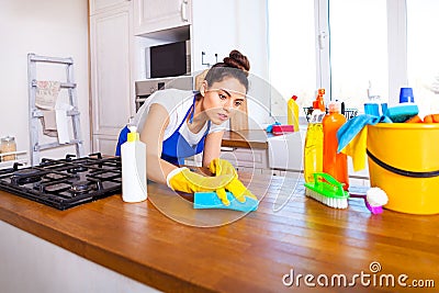 Beautiful young woman makes cleaning the house. Girl cleaning kitchen. Set. Stock Photo