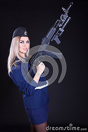 Beautiful young woman in a marine uniform with an assault rifle Stock Photo