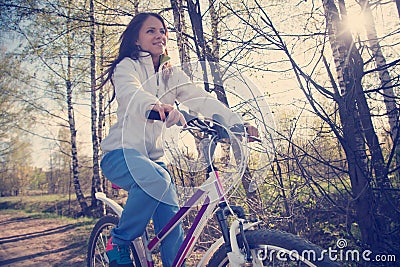 Beautiful young woman with mountain bicycle Stock Photo