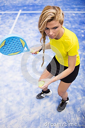 Beautiful young woman playing paddle tennis indoor. Stock Photo