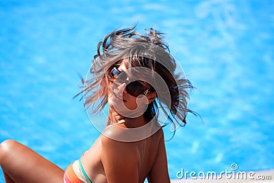 Beautiful young woman at a pool Stock Photo