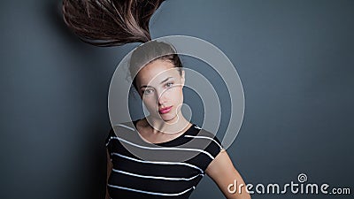 Young pretty woman portrait with ponytail in motion studio shot Stock Photo