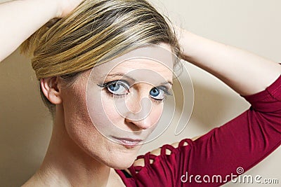 Beautiful young woman portrait with stronger make up holding hair Stock Photo