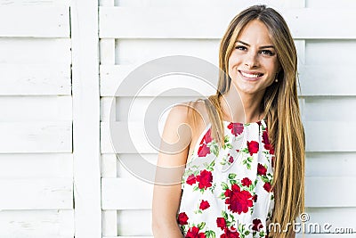 Beautiful young woman posing outdoors and smiling Stock Photo