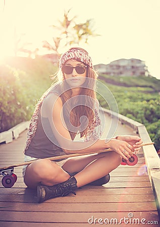 Beautiful young woman posing with a skateboard Stock Photo