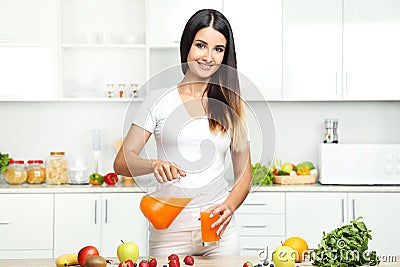 Woman pouring juice in glass Stock Photo