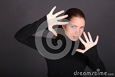 Beautiful young woman with raised hands Stock Photo