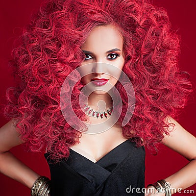 Beautiful young woman with red hair. Bright make-up and hairstyle. Stock Photo