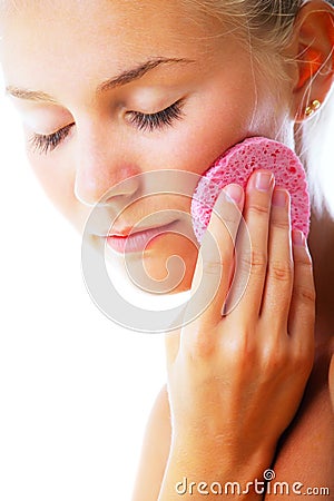 Beautiful young woman removing make-up Stock Photo