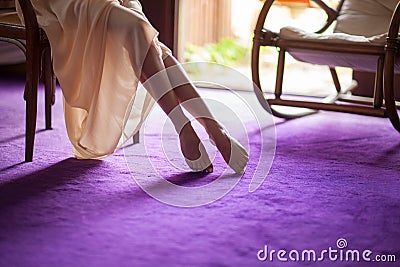 Beautiful young woman`s feet close up at home, soft violet carpet floor Stock Photo