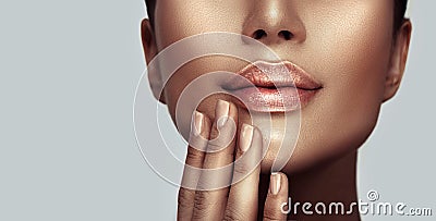 Beautiful young woman`s lips closeup. Plastic surgery, fillers, injection. Model girl`s face, healthy nails, and perfect skin Stock Photo