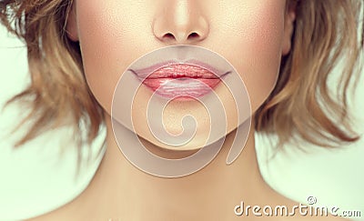 Beautiful young woman`s lips closeup. Plastic surgery, fillers, injection. Part of the model girl face, youth concept Stock Photo