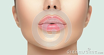 Beautiful young woman`s lips closeup. Plastic surgery, fillers, injection. Part of the model girl face, youth concept Stock Photo