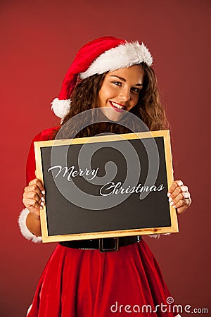 Beautiful young woman in santa dres holds blackboard over red ba Stock Photo