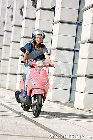 Beautiful young woman on scooter Stock Photo